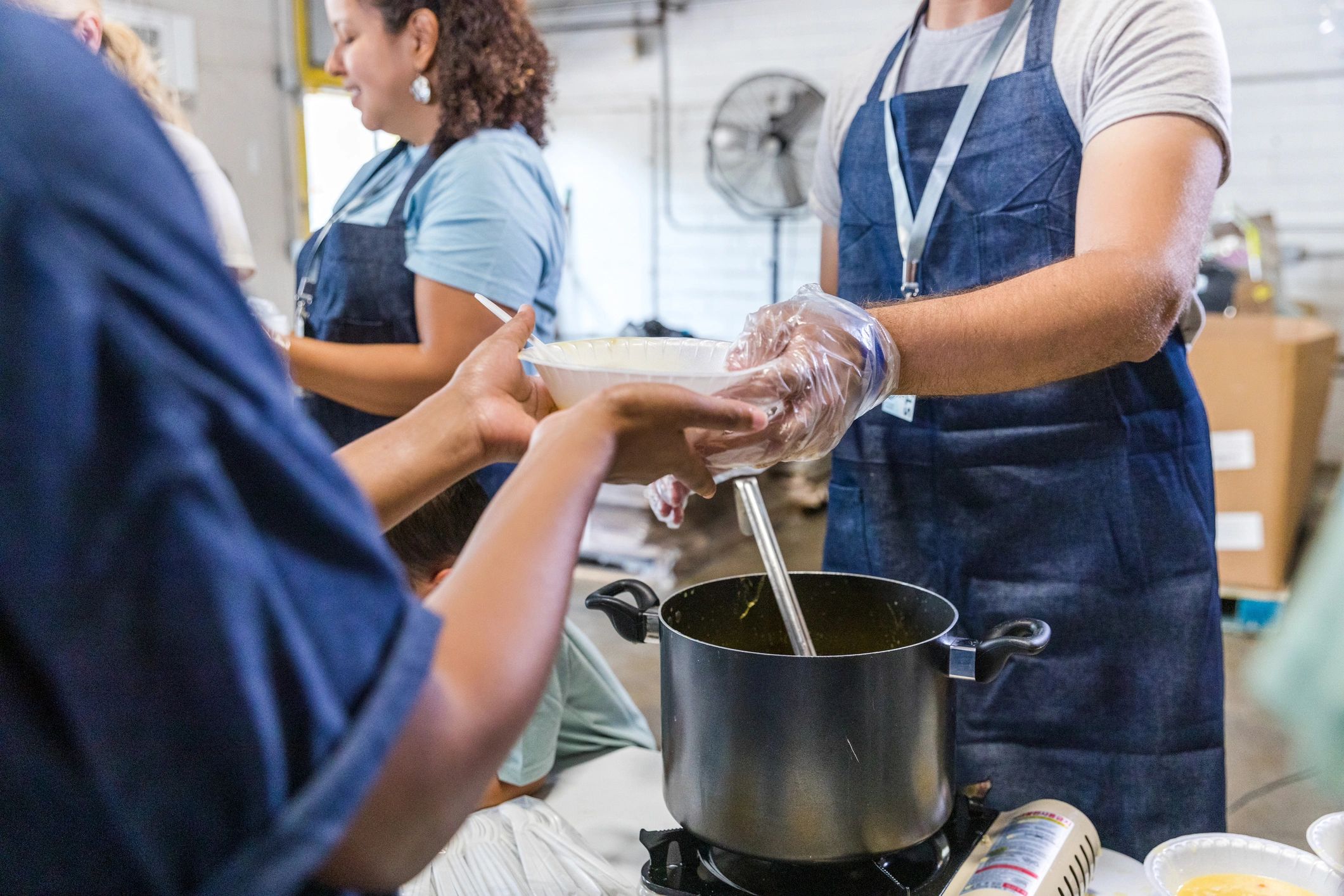 Serving soup to a woman in need