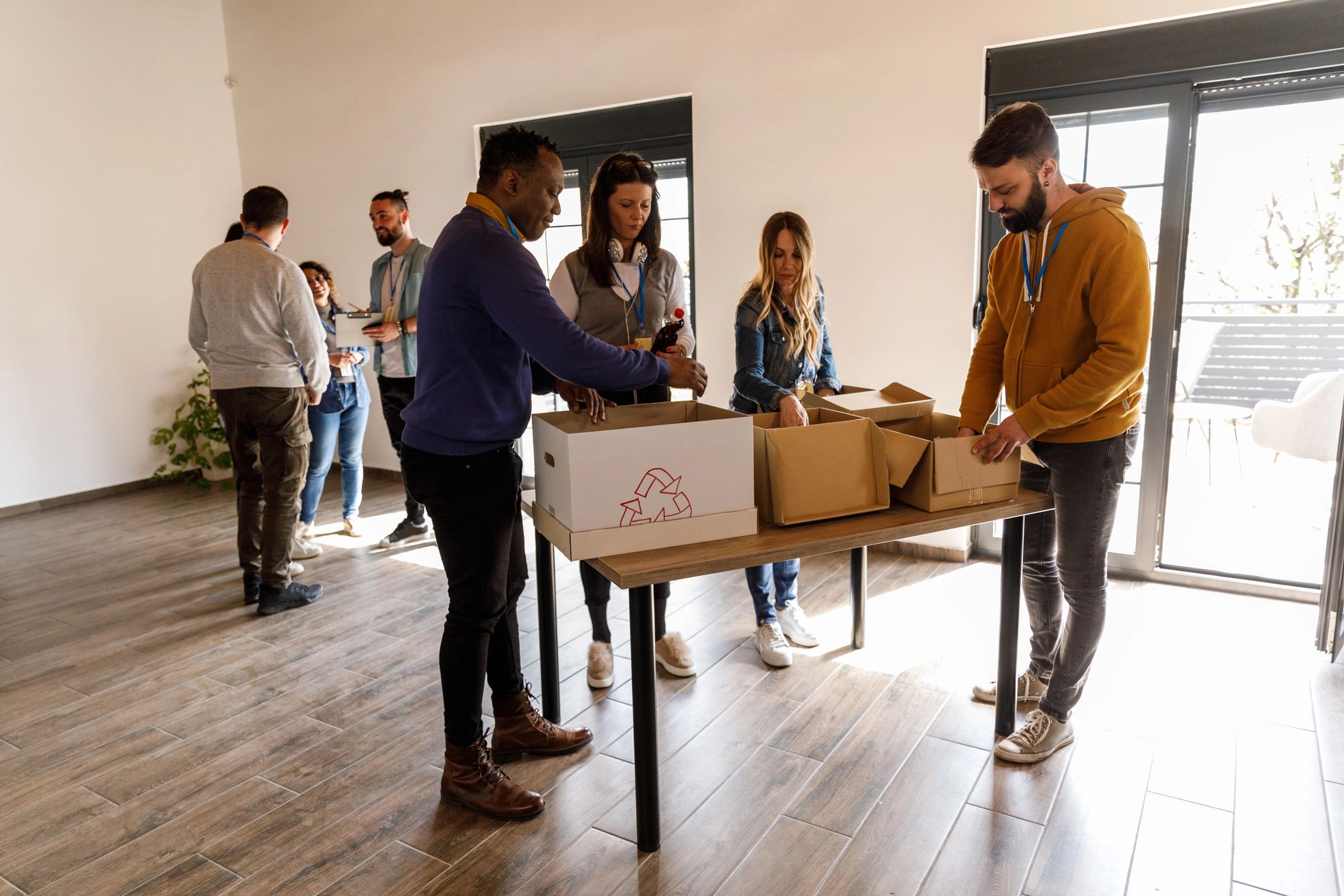 Diverse volunteers sorting donation boxes together