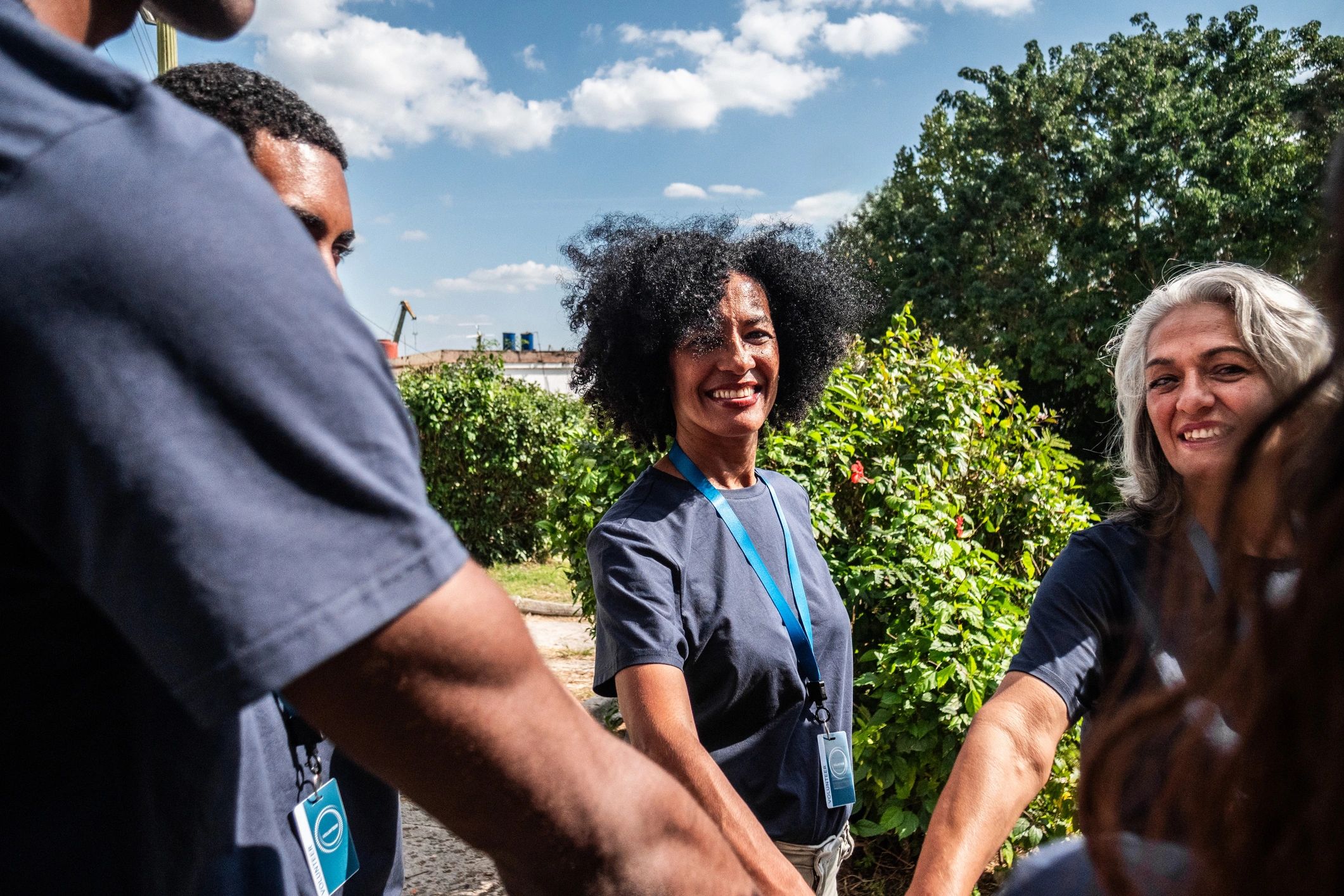 Volunteers joining hands in support of families and community care