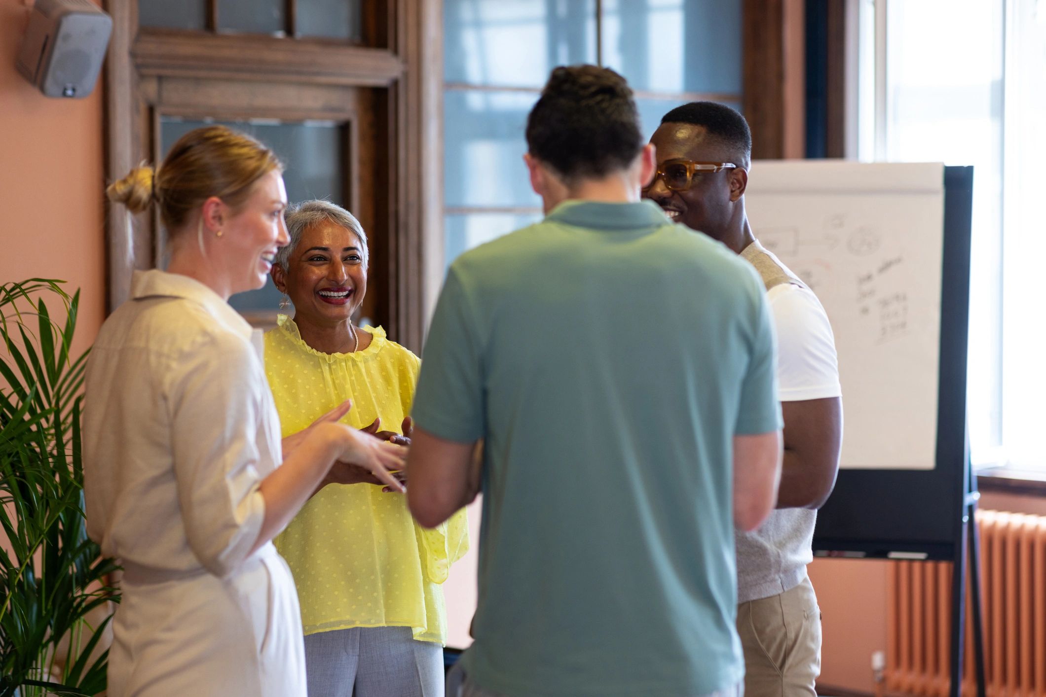 Team members collaborating around a flipchart
